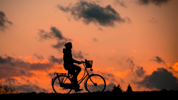 Silhouette eines Radfahrers vor dem Hintergrund eines Sonnenuntergangs Silhouette eines Radfahrers vor dem Hintergrund eines Sonnenuntergangs