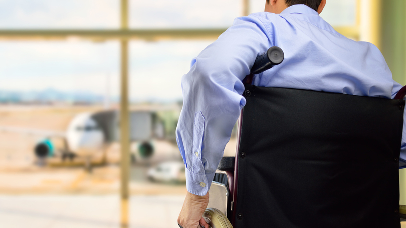Person in a weelchair at the airport Person in a weelchair at the airport