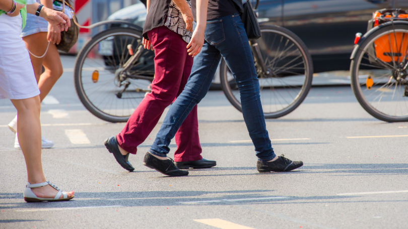 Several pedestrians are crossing a street Several pedestrians are crossing a street